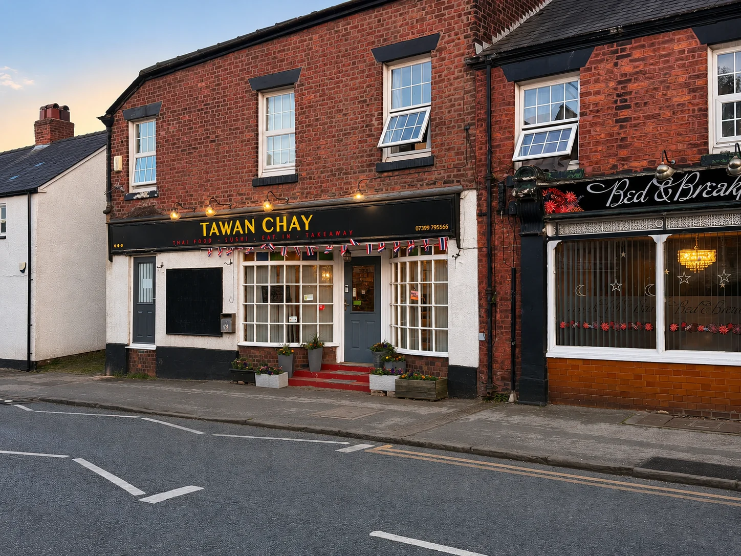 Tawan Chay on High Street, Weaverham, lit up in the evening
