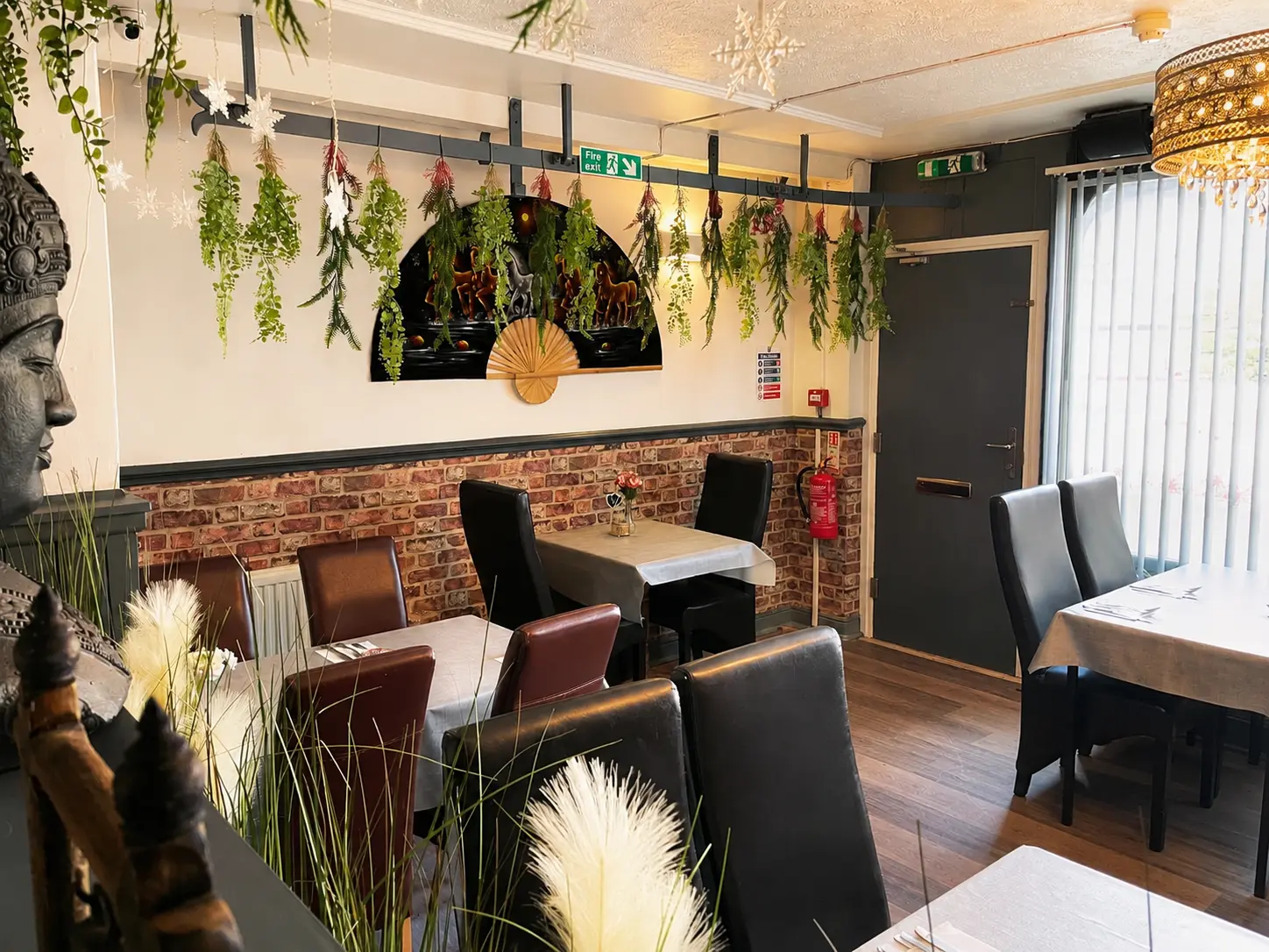 The dining room at Tawan Chay, with plants and warm lighting