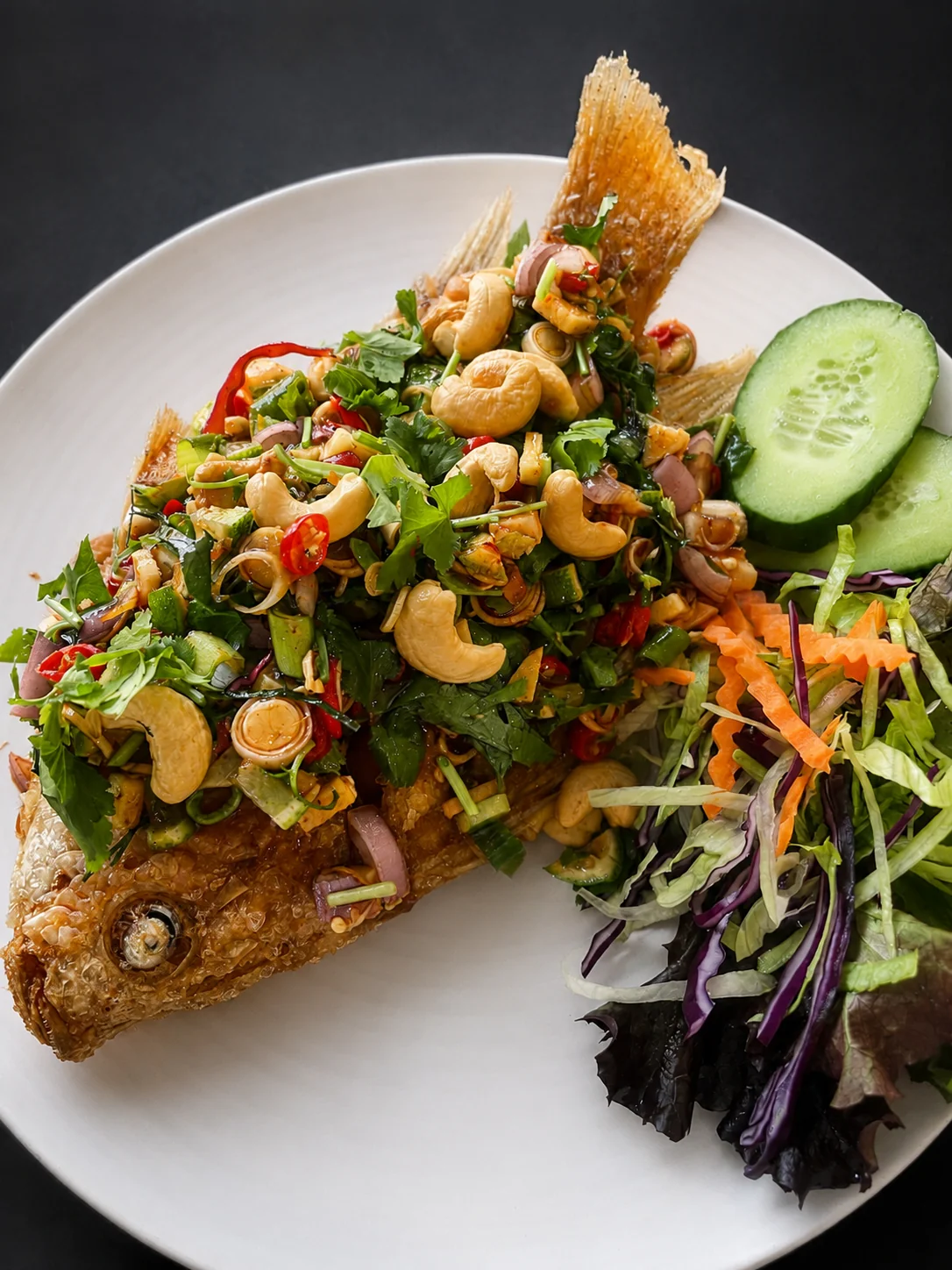 Crispy fried fish with herb and cashew salad